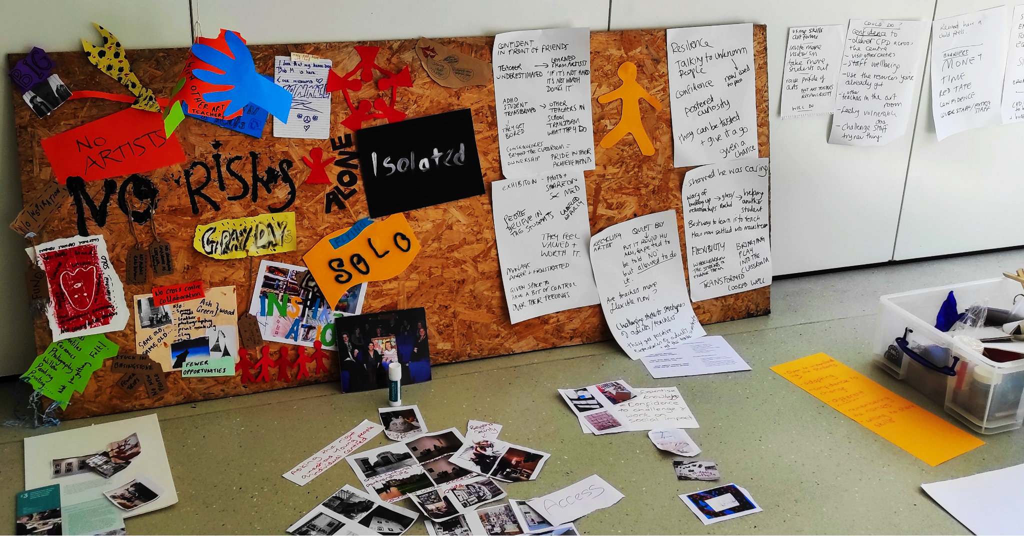 An assortment of participatory artwork, signs and notes attached to a pinboard and wall